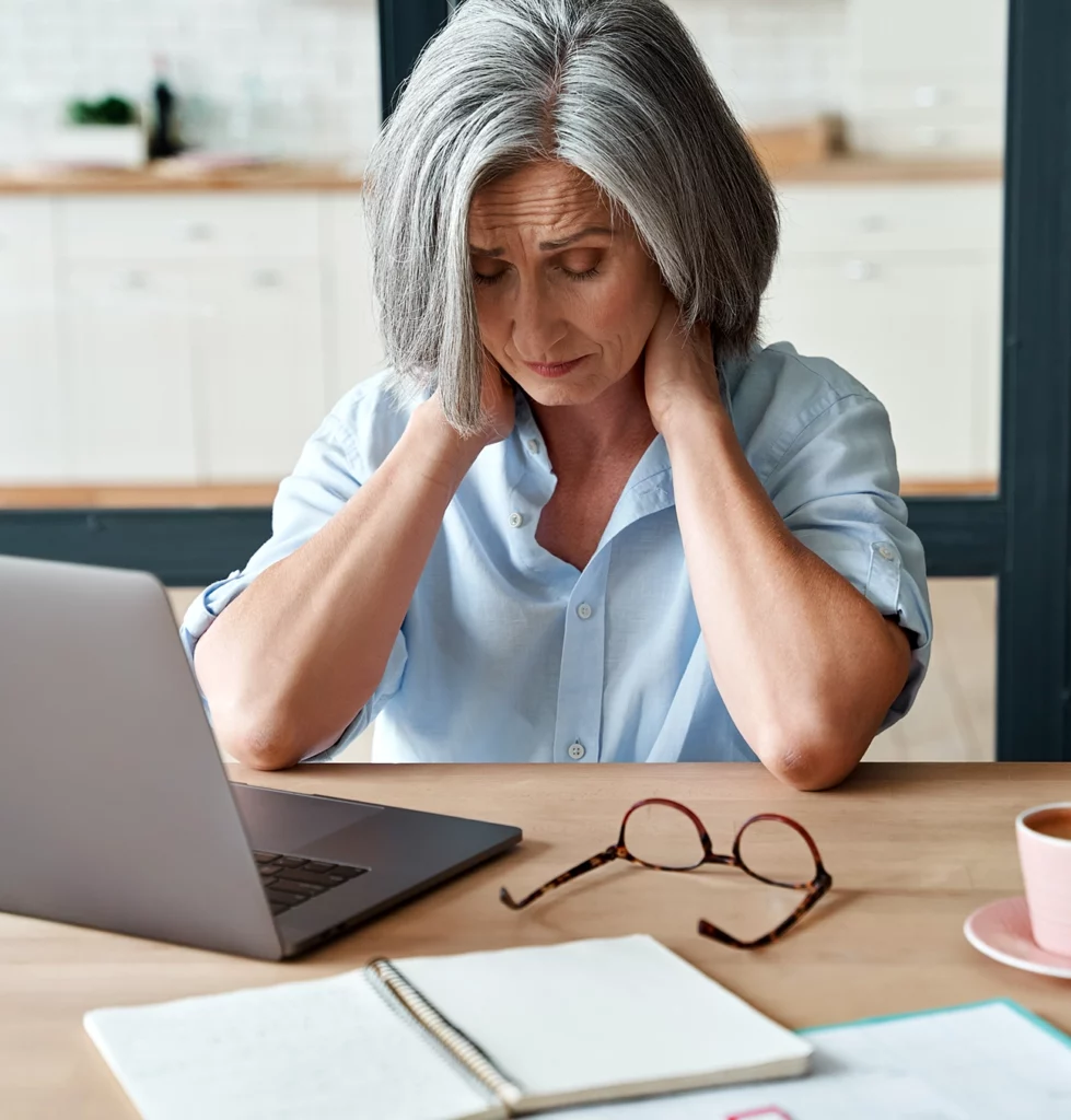Senior Woman stressed at desk